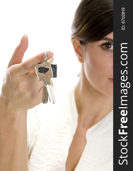 Lady with keys in her finger with white background