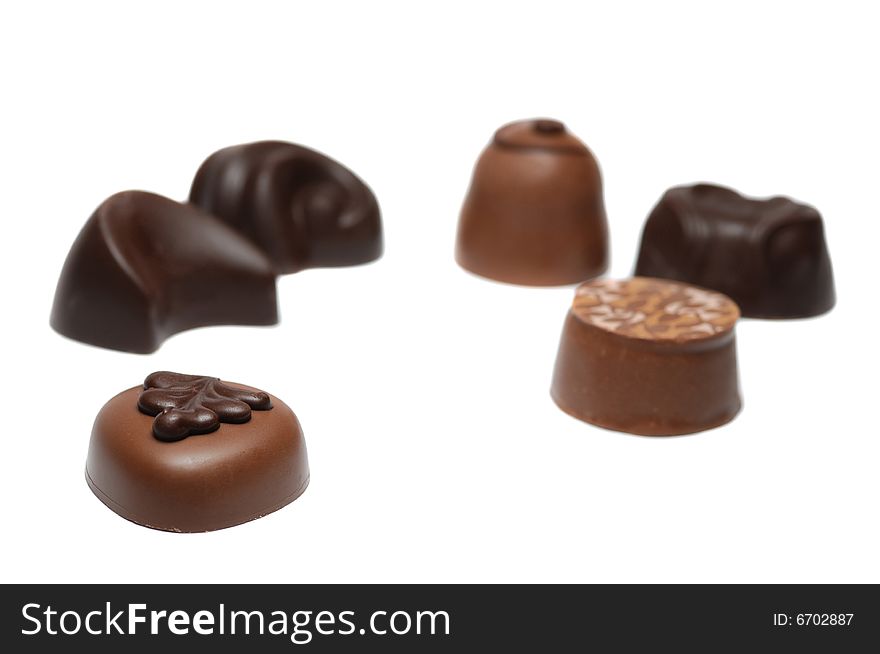 Sorted chocolate candies isolated - shallow dof, focus on first candy