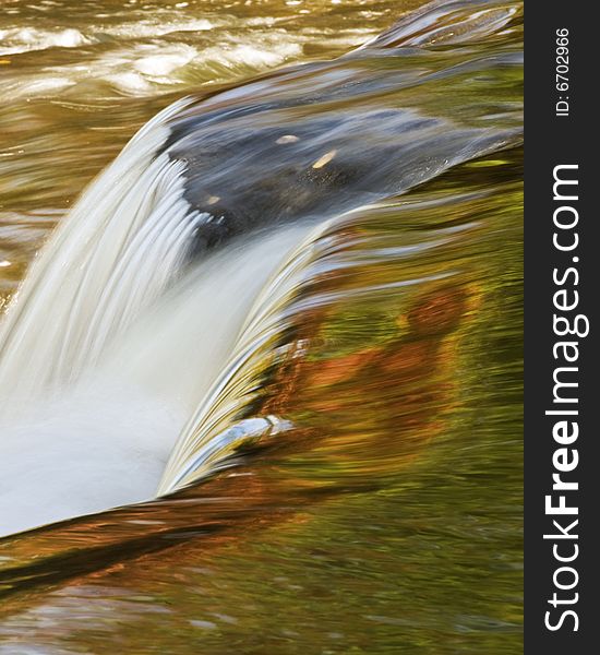 Bond Falls in Upper Peninsula of Michigan from the top showing colors reflecting from the fall foliage. Bond Falls in Upper Peninsula of Michigan from the top showing colors reflecting from the fall foliage.