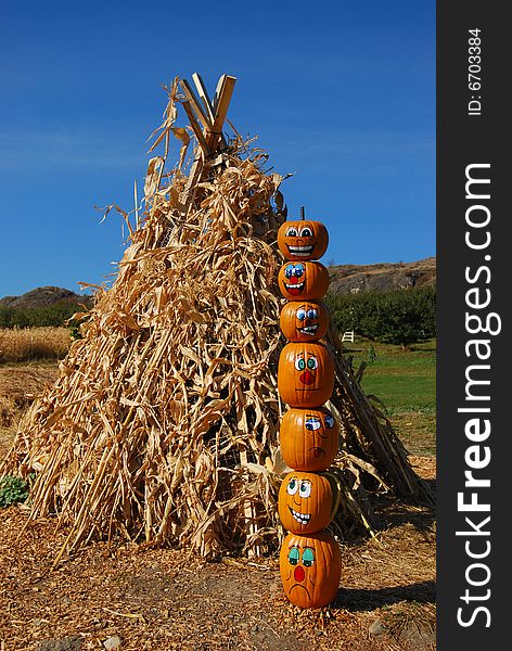 Pumpkin puppets totem pole on a farmers market