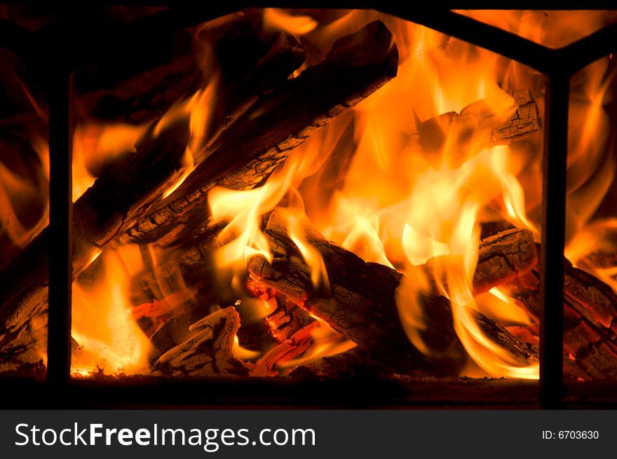 Flames flicker in a fireplace, providing warmth for all. Flames flicker in a fireplace, providing warmth for all