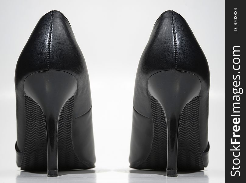 A pair of black high heeled woman's shoes. A pair of black high heeled woman's shoes