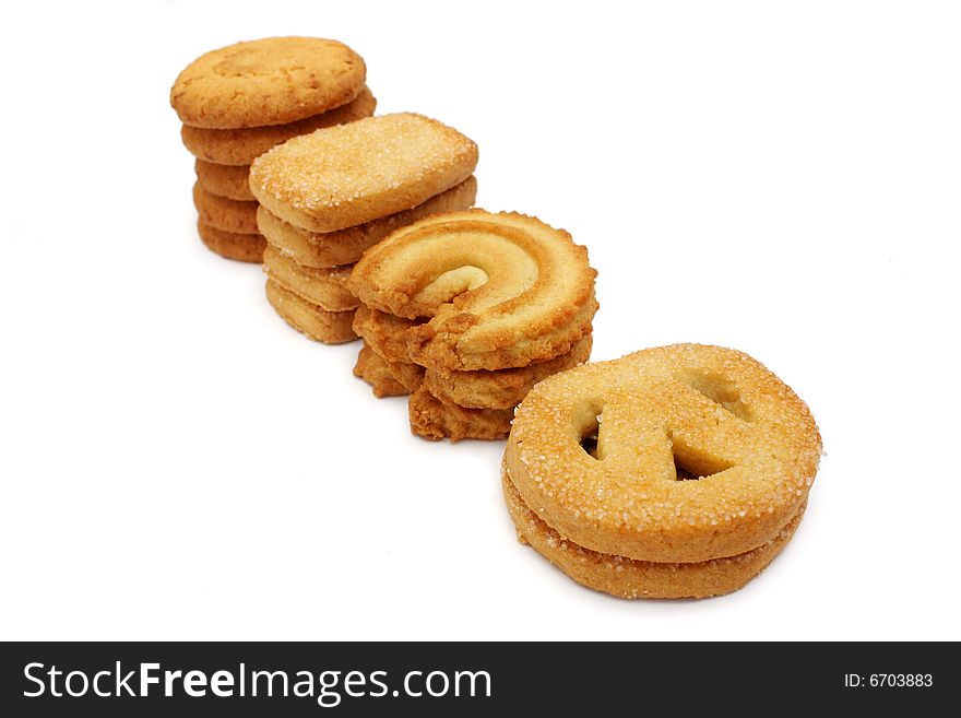 Many pieces of cookies stacked on white background.