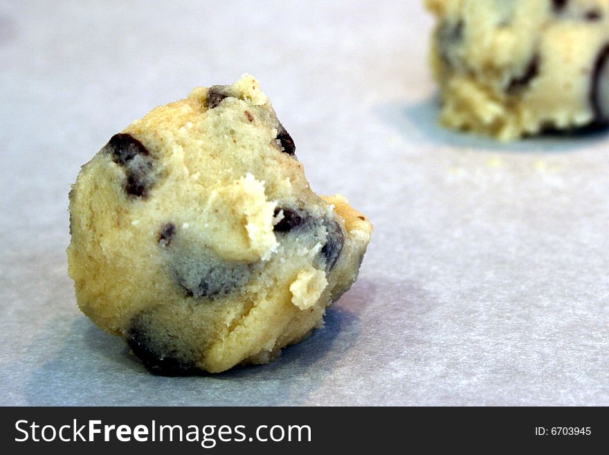 Chocolate chip cookie dough on parchment paper