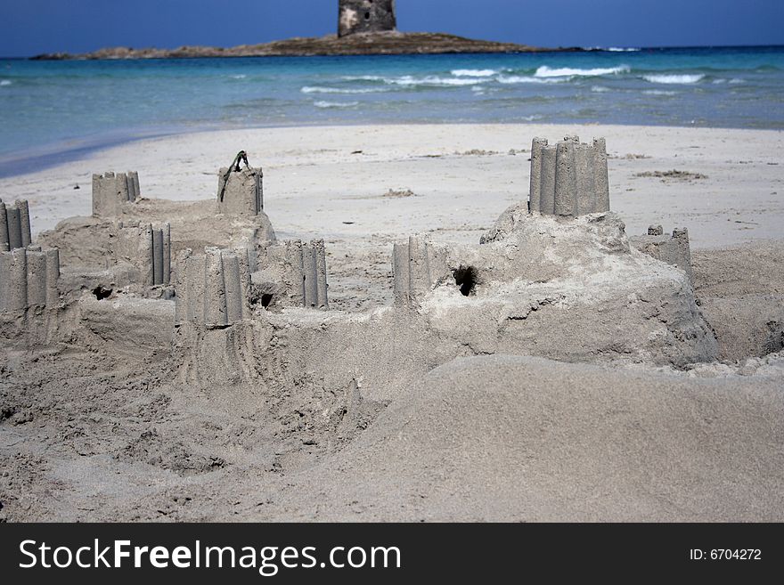 Sand castle with real castle as a background, Stintino, Sardinia island, Italy. Sand castle with real castle as a background, Stintino, Sardinia island, Italy