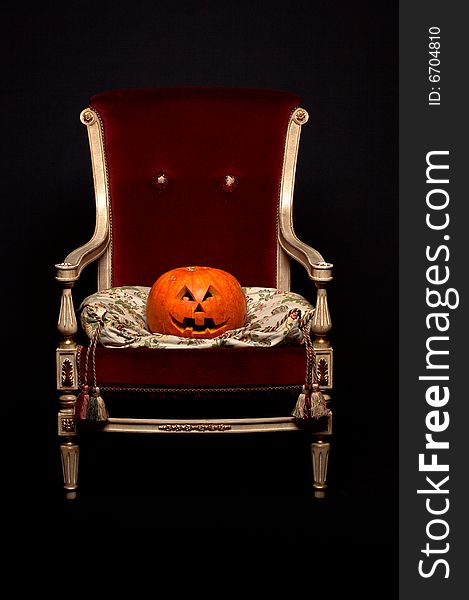 Pumpkin sitting like a king in comfortable arm-chair. Pumpkin sitting like a king in comfortable arm-chair