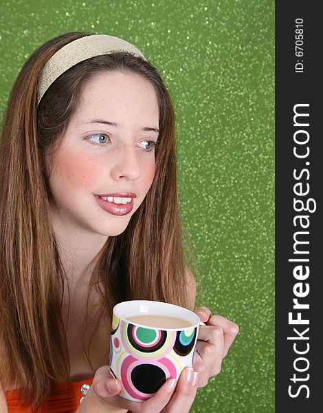 Brunette teenager on a green background wearing a broad head band. Brunette teenager on a green background wearing a broad head band