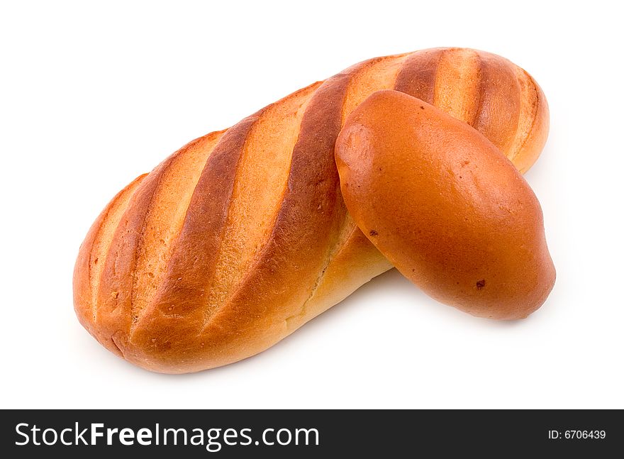 Rich tasty pie lays on cut long loaf bread baked wheat flour on white background