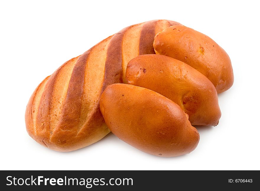 Rich tasty pie lays on cut long loaf bread baked wheat flour on white background