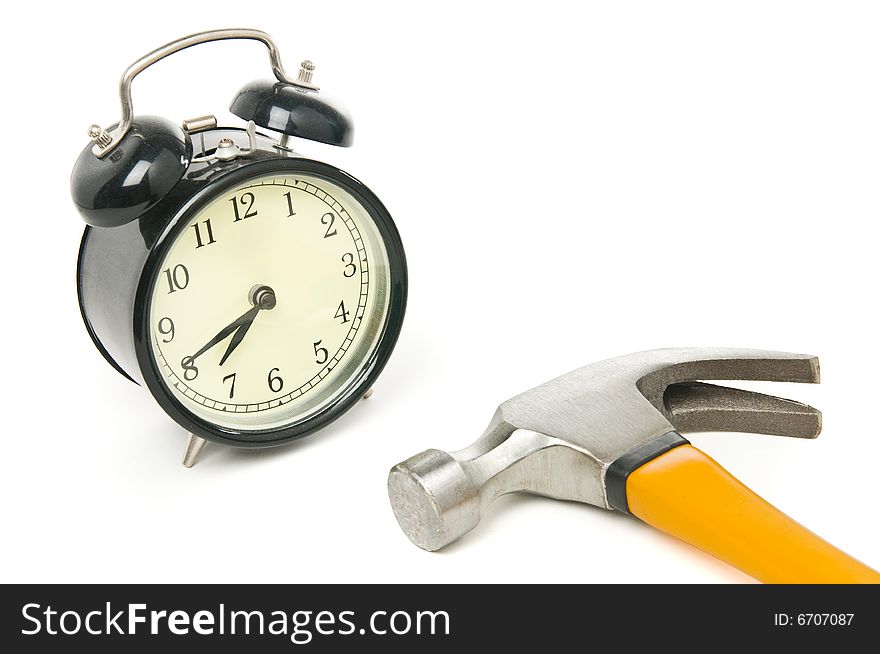 Alarm clock and  hammer isolated on a white