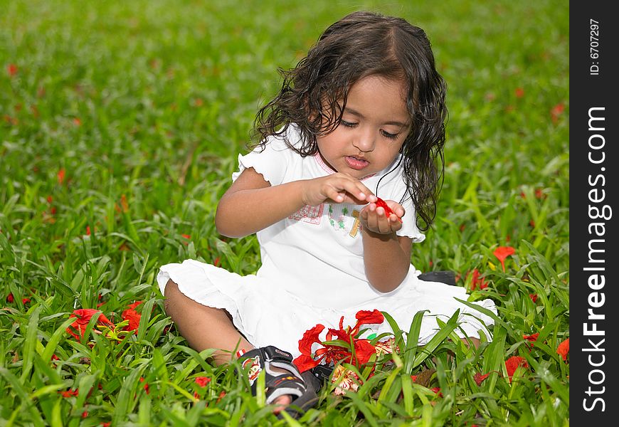 Asian girl of indian origin playing in a park. Asian girl of indian origin playing in a park