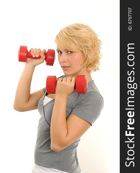 Young woman doing exercise with two red dumbbell.