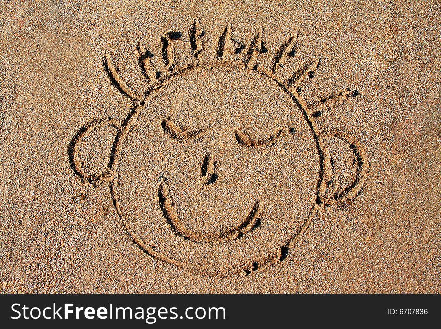 Funny smiley on wet sand