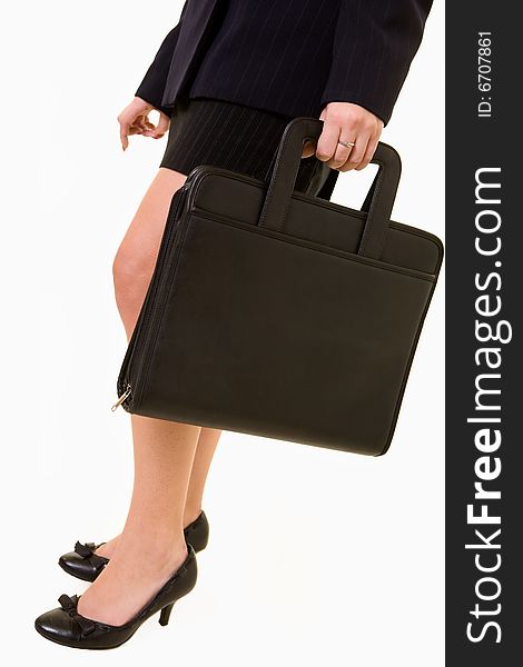 Legs of business woman standing on white wearing black skirt and carrying a briefcase or portfolio. Legs of business woman standing on white wearing black skirt and carrying a briefcase or portfolio