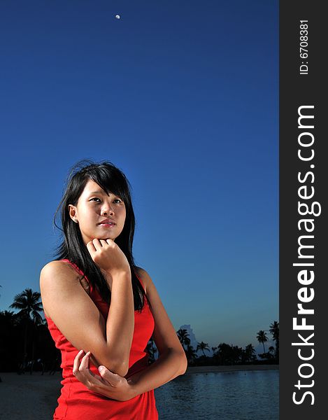 Woman posing at night at the beach. Woman posing at night at the beach.