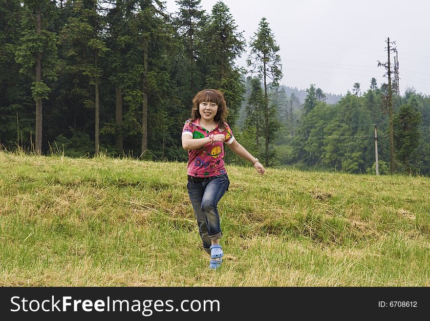 A girl running on the Grassland. A girl running on the Grassland