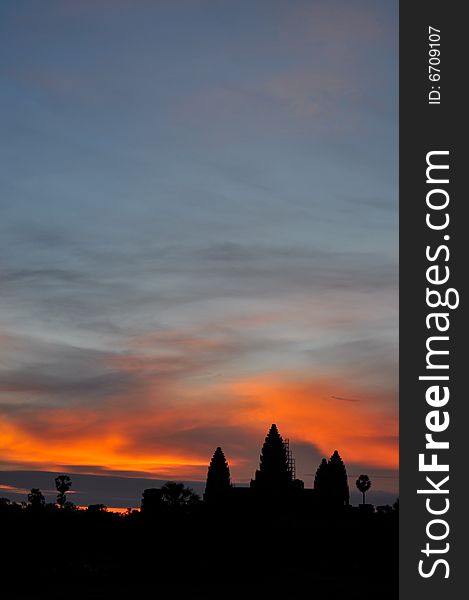 Angkor Wat in silhouette during sunrise. Angkor Wat in silhouette during sunrise.