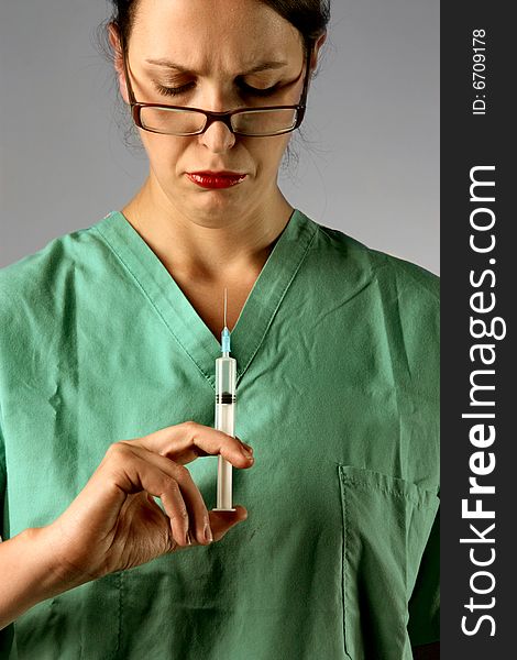 A  doctor holding a syringe