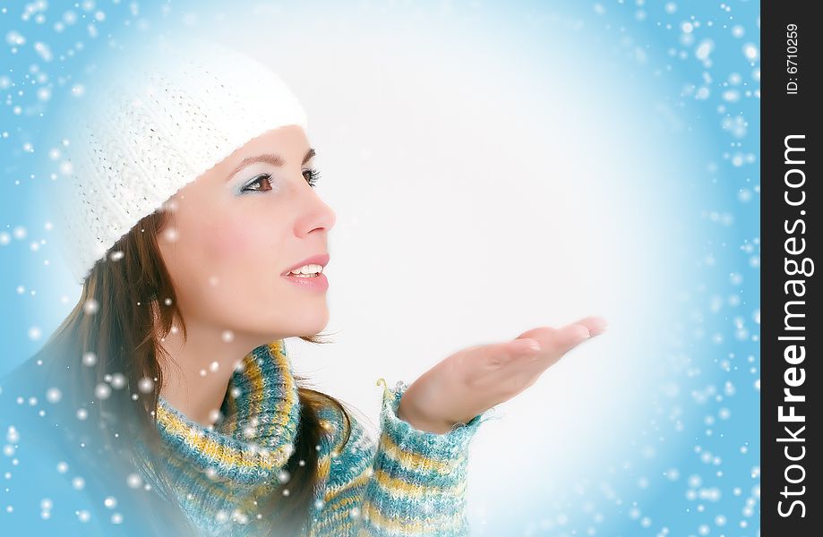 Winter Girl blowing snowflakes, blue background