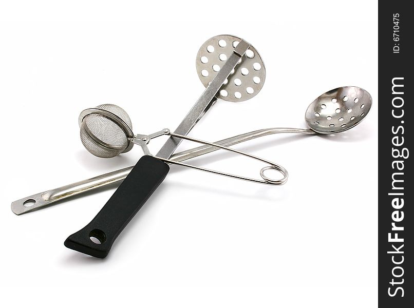 Two perforated spoons and tea strainer isolated on a white background