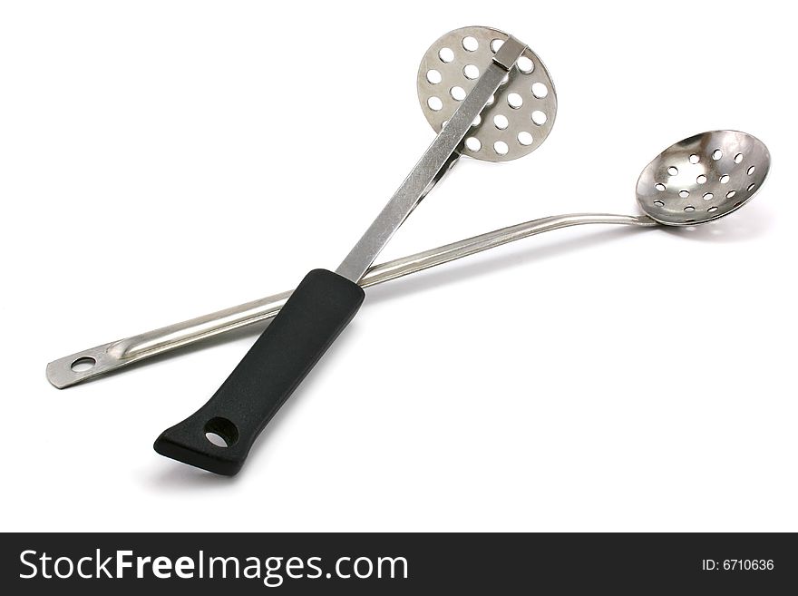 Two perforated spoons isolated on a white background