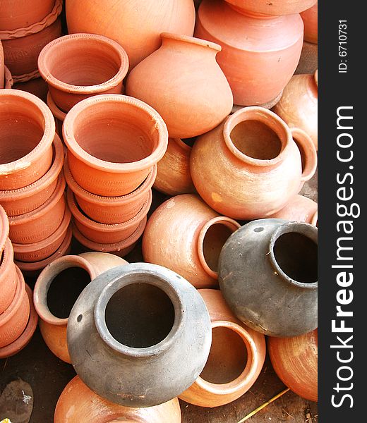 A group of different shaped earthen pots made out of clay