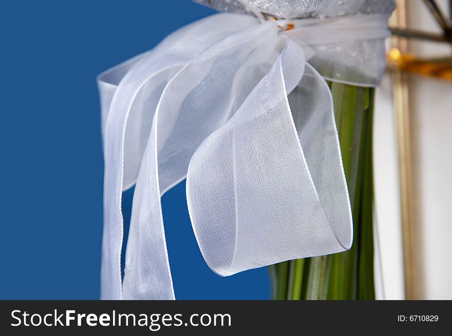 The bouquet basis is tied up by a silk bow