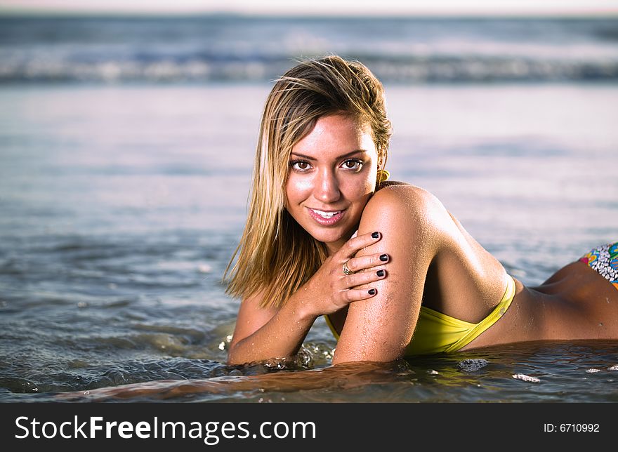 Sexy Blond laying on the beach in a Bikini. Sexy Blond laying on the beach in a Bikini