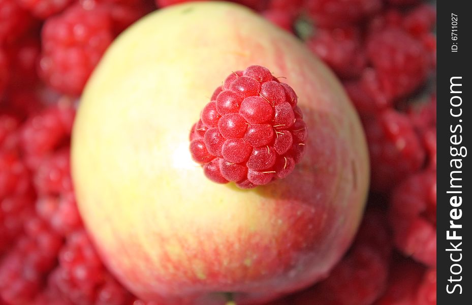 Close up of the juicy raspberry on the apple. Close up of the juicy raspberry on the apple.