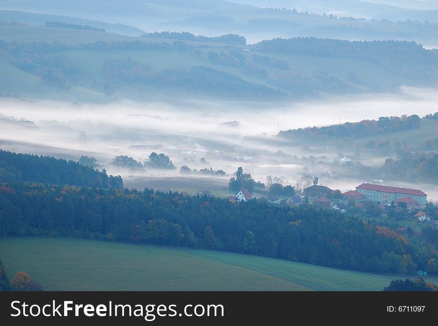 Autumn landscape with fog and coloured tree