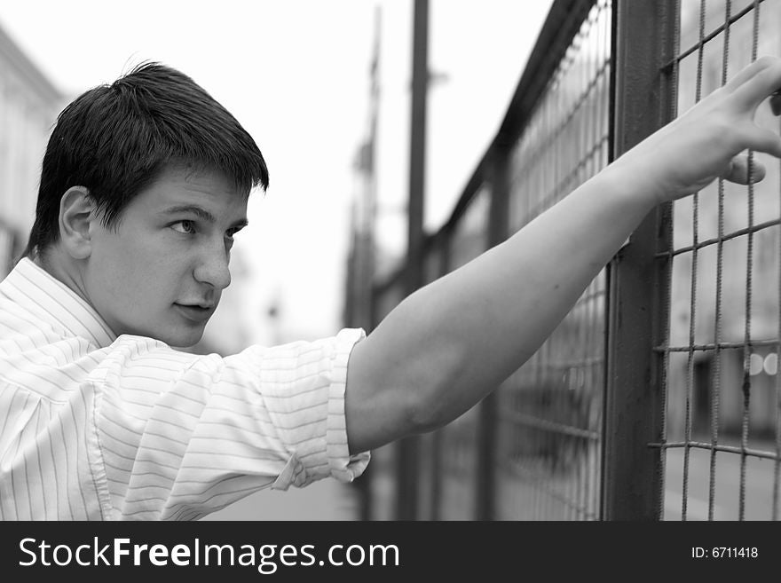 The young man pushes an iron lattice