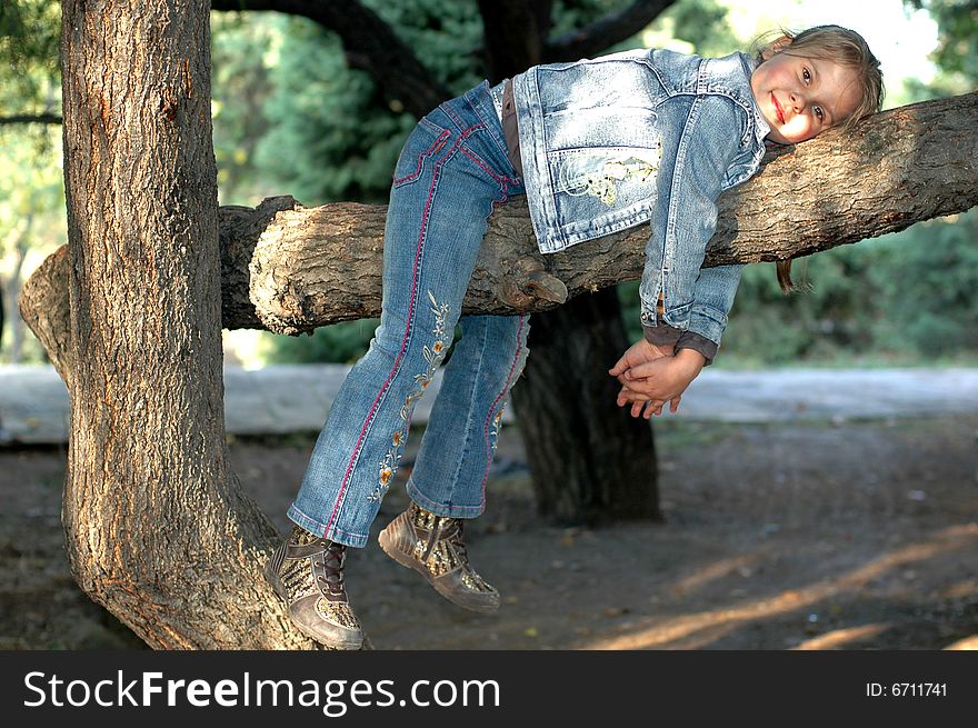Little girl lieing on the tree. Little girl lieing on the tree