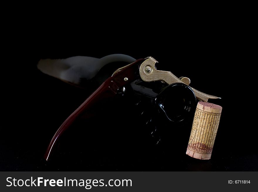 Corkscrew for opening wine bottles on black background