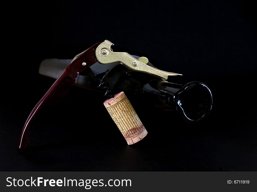 Corkscrew for opening wine bottles on black background