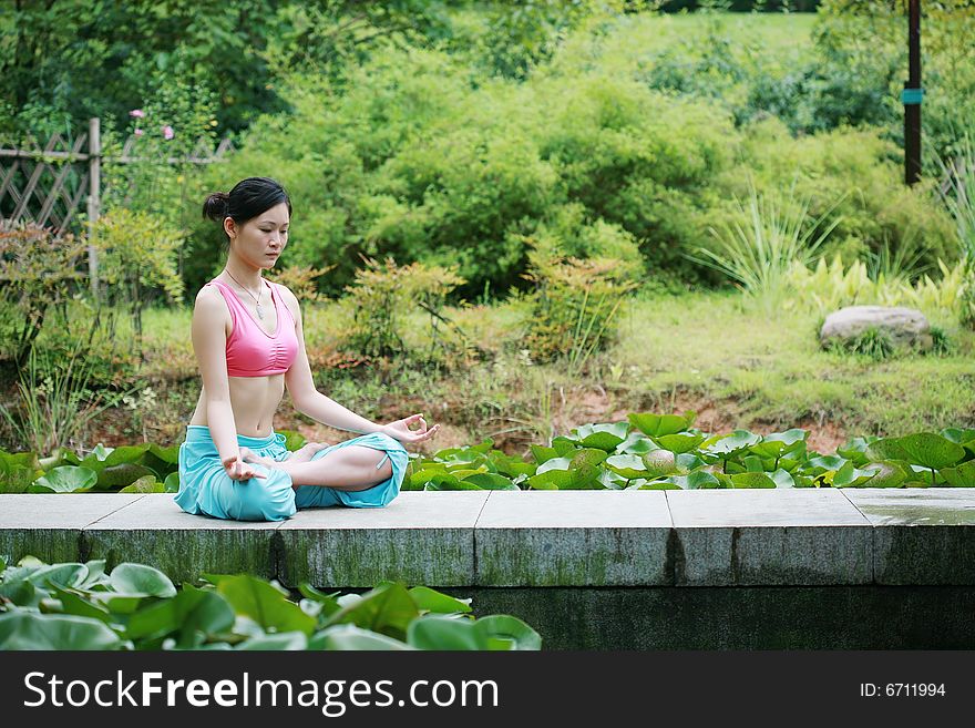 Young Chinese Woman Practicing Yoga Outdoor