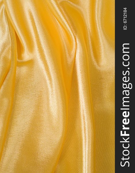Fragment of yellow undulating material, abstract background. Fragment of yellow undulating material, abstract background