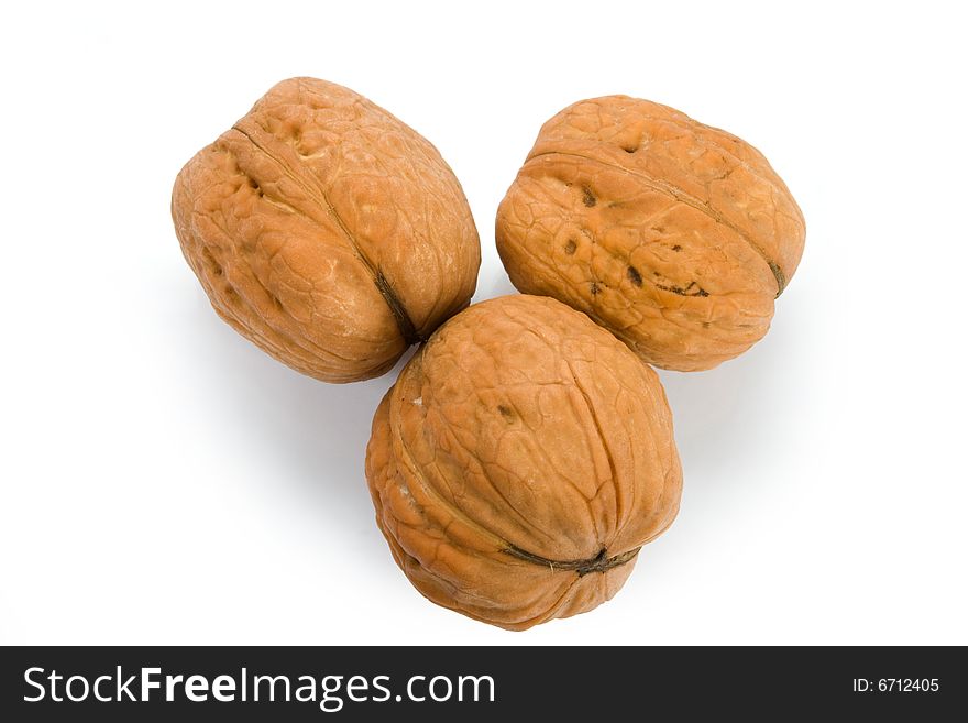 Three walnuts on white background