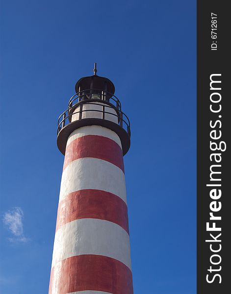 Small old lighthouse under blue skies. Small old lighthouse under blue skies