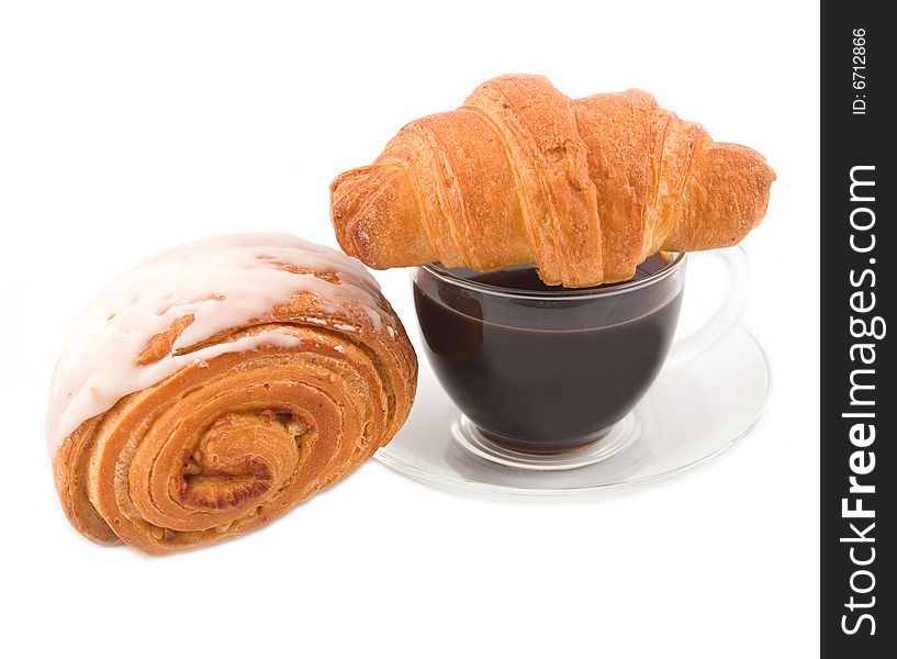 Puff fresh and tasty rolls with white glaze with cup of black coffee on white background