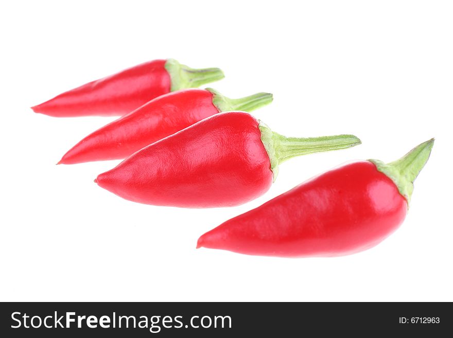 Four chili peppers isolated on a white background