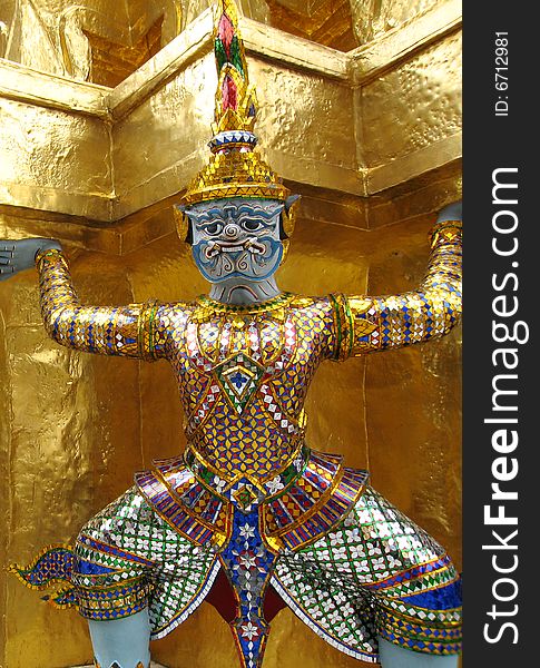 Thailand, Bangkok, Grand Palace, Temple of the Emerald Buddha, Yaksha supporting golden chedi. Thailand, Bangkok, Grand Palace, Temple of the Emerald Buddha, Yaksha supporting golden chedi