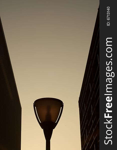 Silhouette of a modern street lamp with gradient sky