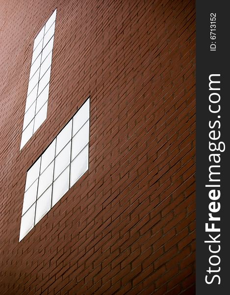 Red brick wall texture with modern glass windows