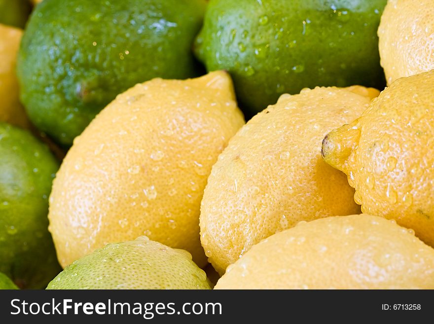 Lemon lime orange fruit set close up and water drops in the set. Lemon lime orange fruit set close up and water drops in the set