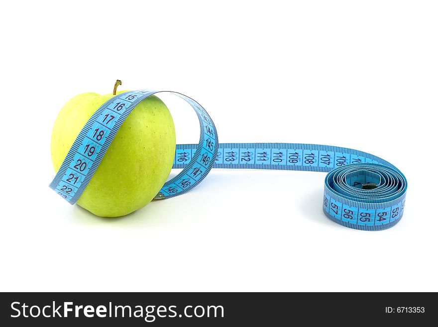 Green apple surrounded with  tape measure isolated on white. Green apple surrounded with  tape measure isolated on white