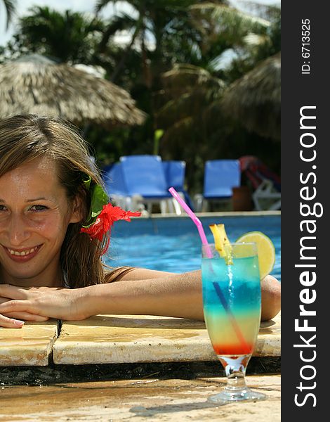 Woman in swimming pool with fresh cocktail. Woman in swimming pool with fresh cocktail