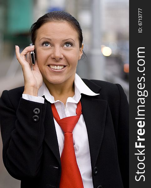 Portrait of pretty businesswoman speaking by phone