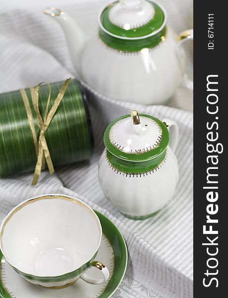 White with green tea service and gift box on napkin