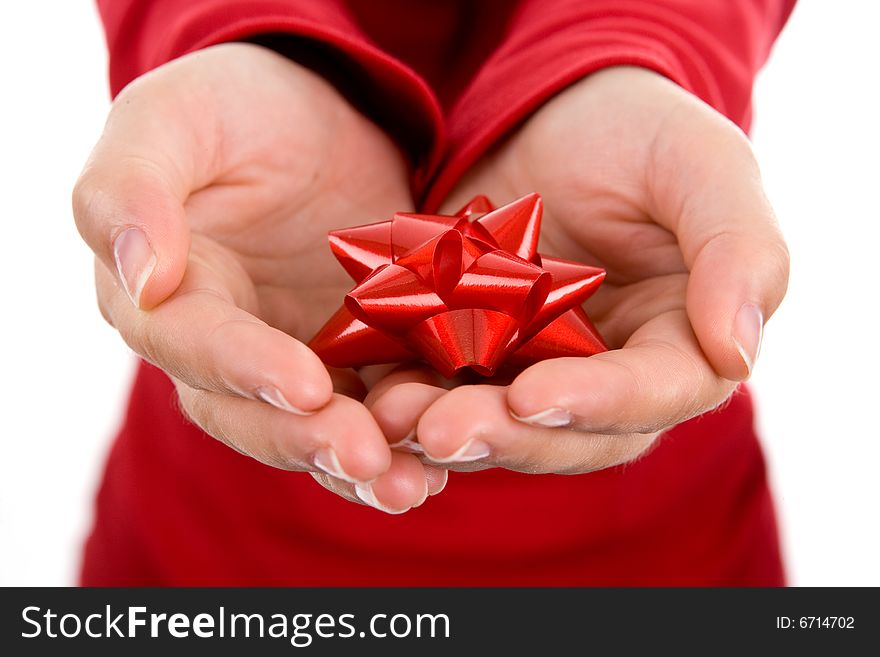 Young woman gently holding red ribbon with both hands isolated on white background. Young woman gently holding red ribbon with both hands isolated on white background