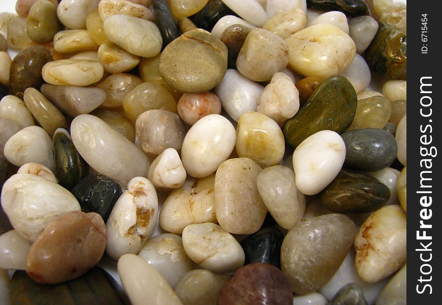 An assortment of small, natural, polished stones. An assortment of small, natural, polished stones
